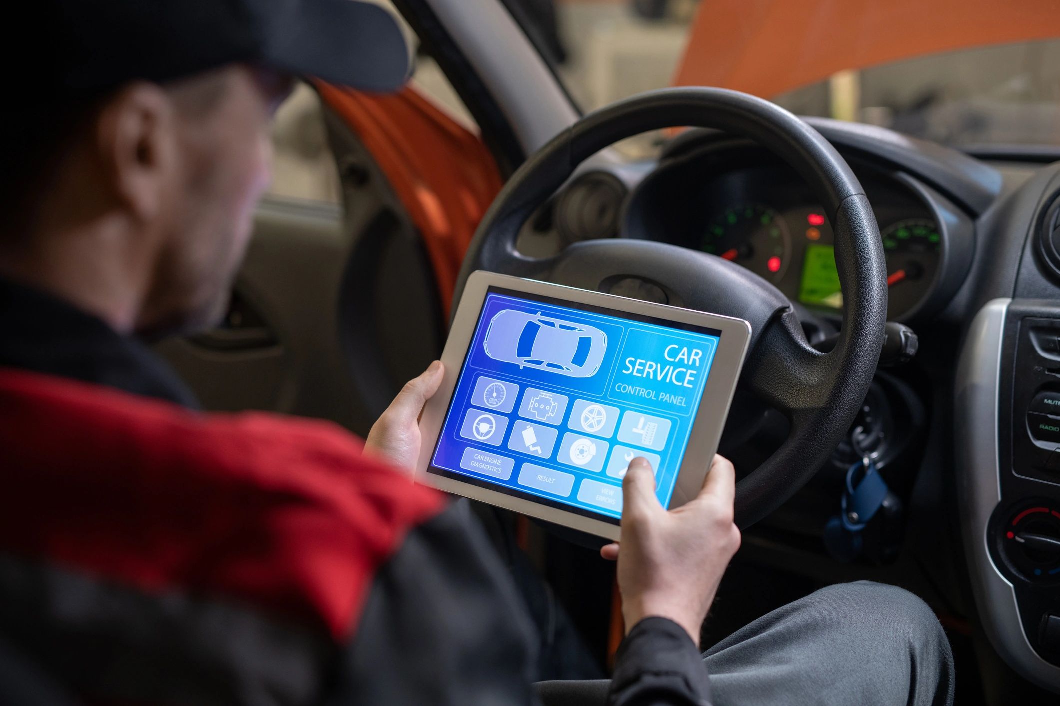 Technician using a tablet during a vehicle inspection