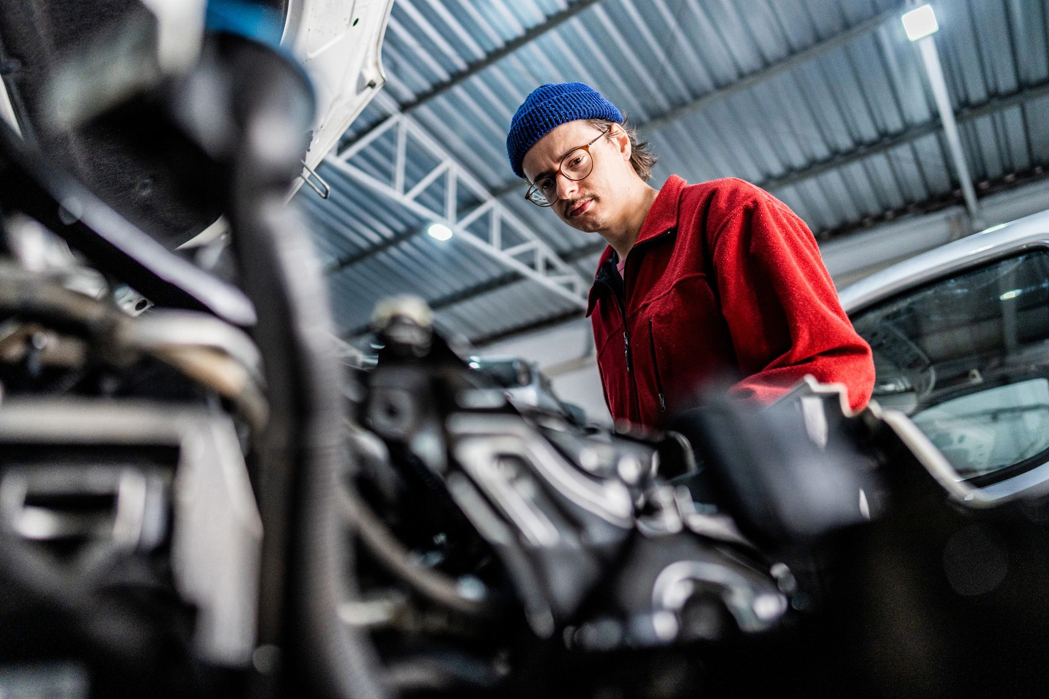 ASE-certified mechanic working on a vehicle in a clean repair bay